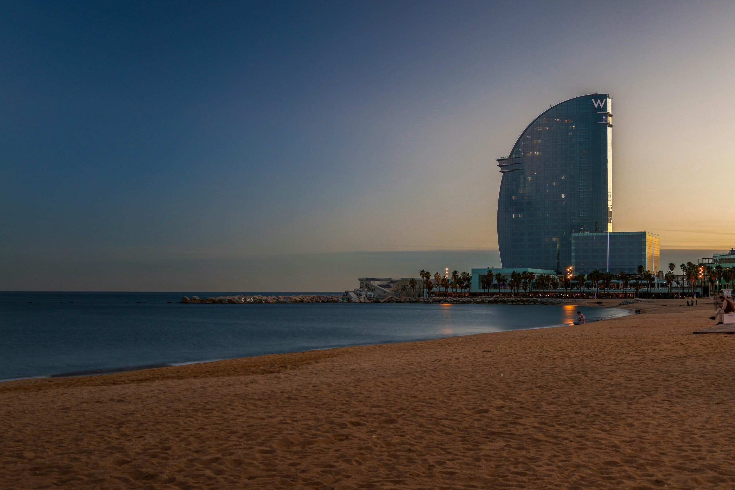 W Barcelona's iconic sail-shaped architecture against Barcelona skyline