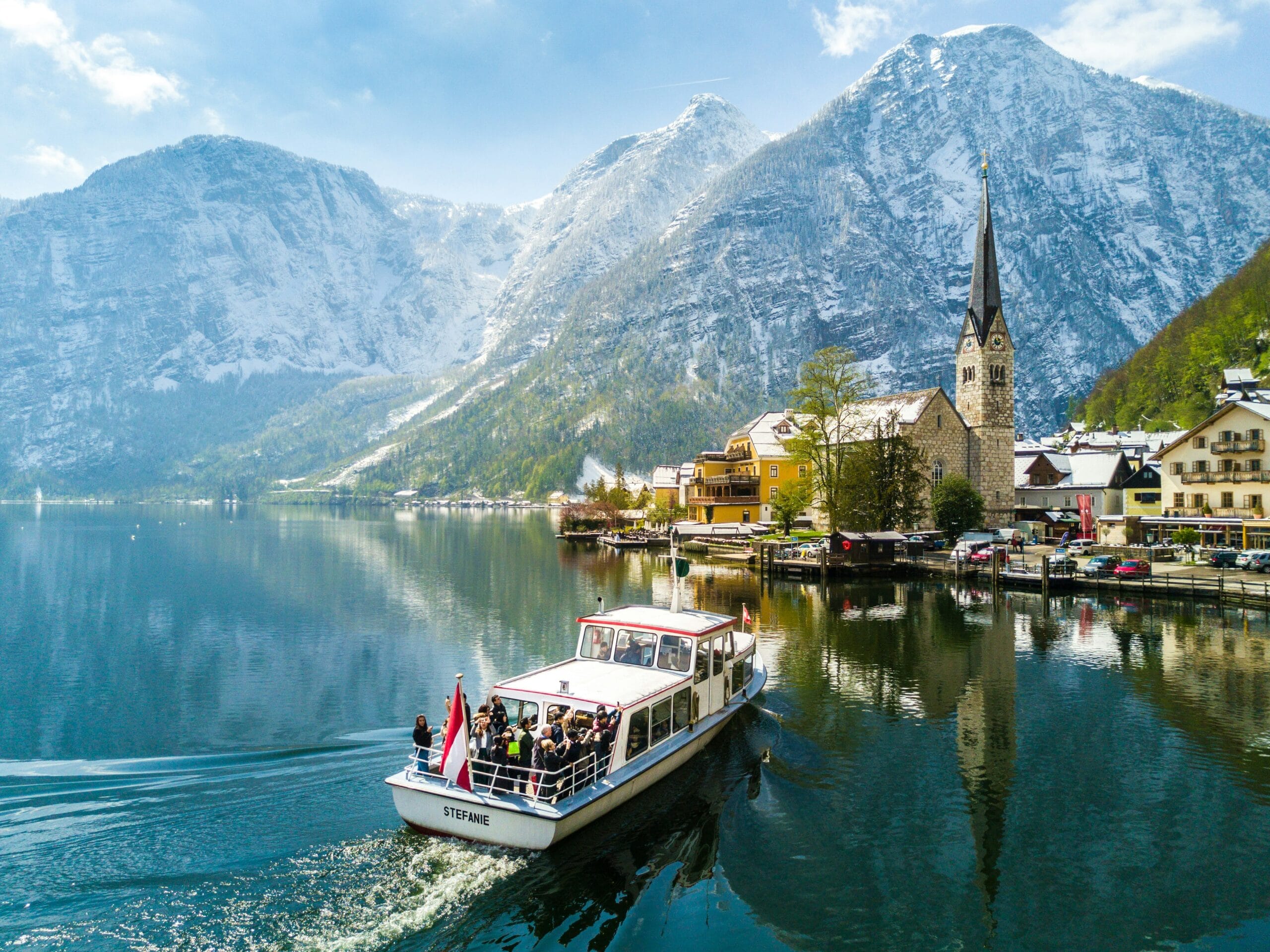 Lake Hallstatt with boats and mountain reflections
