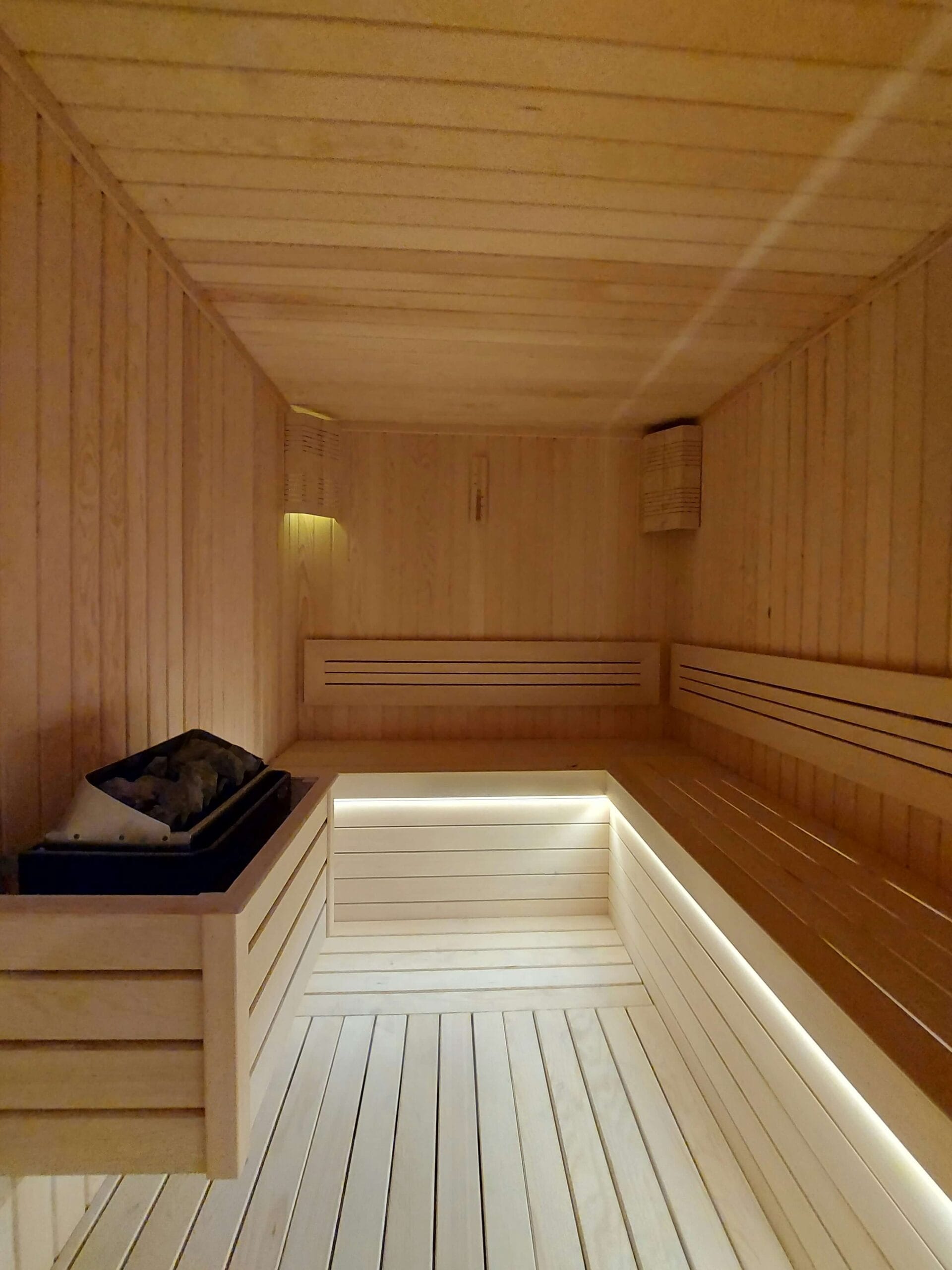 Traditional Norwegian sauna interior with cedar wood and authentic heating elements